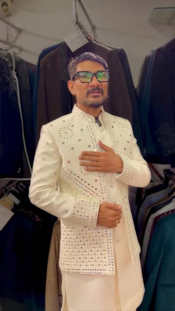 A man in an ivory mirror-work sherwani at the studio