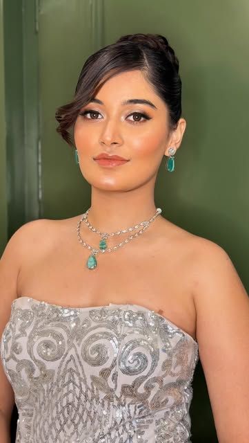 A woman in a silver sequin corset gown
